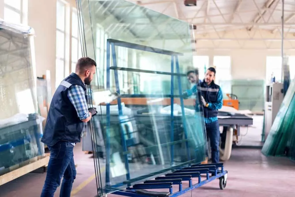 Reinforced glass being inspected by workers at Crown Glass manufacturing facility in Canada. High-quality, custom glass solutions for residential and commercial projects.